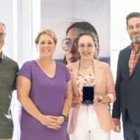 Un élève, accompagnée de sa mère, reçoit la médaille académique du gouverneur général